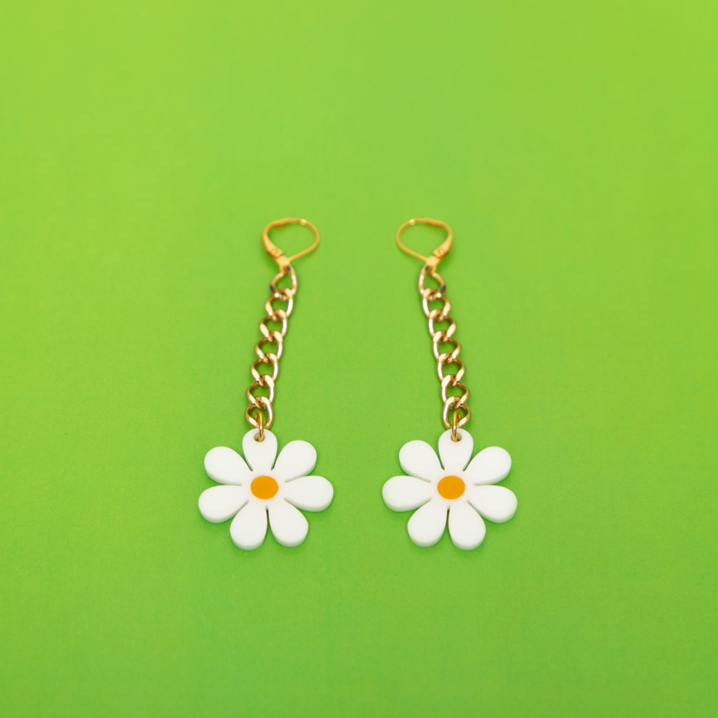 The Baby Daisy Chain Earrings, gold chain with white daisy.